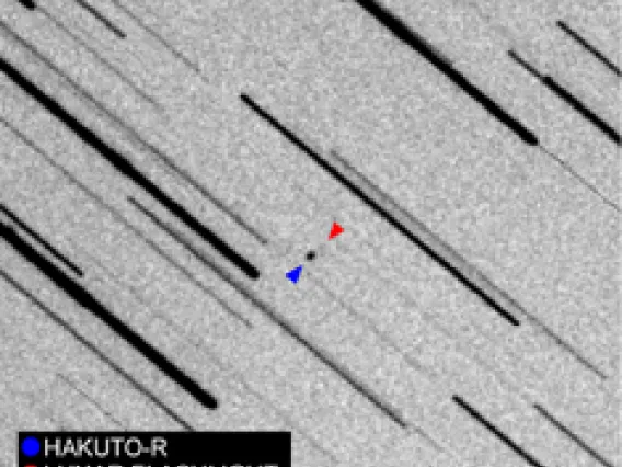 Image showing observations of two spacecraft, seen as dots, on their way to the moon.