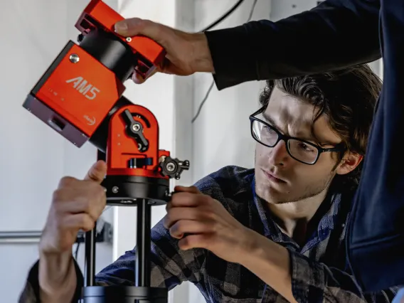 A photo of a student setting up equipment for Space4.