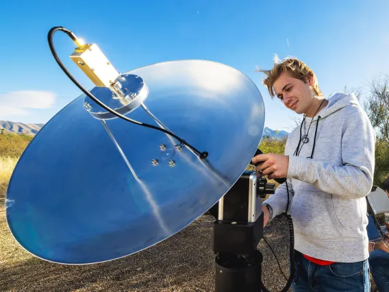 A photo of a student setting up an RF dish.
