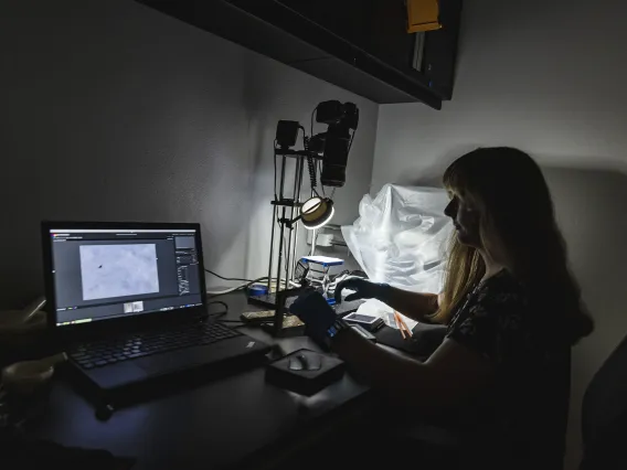 Photo of a student in a lab.