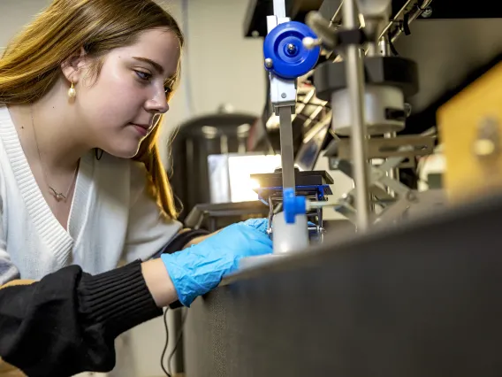 Photo of a student in a lab.