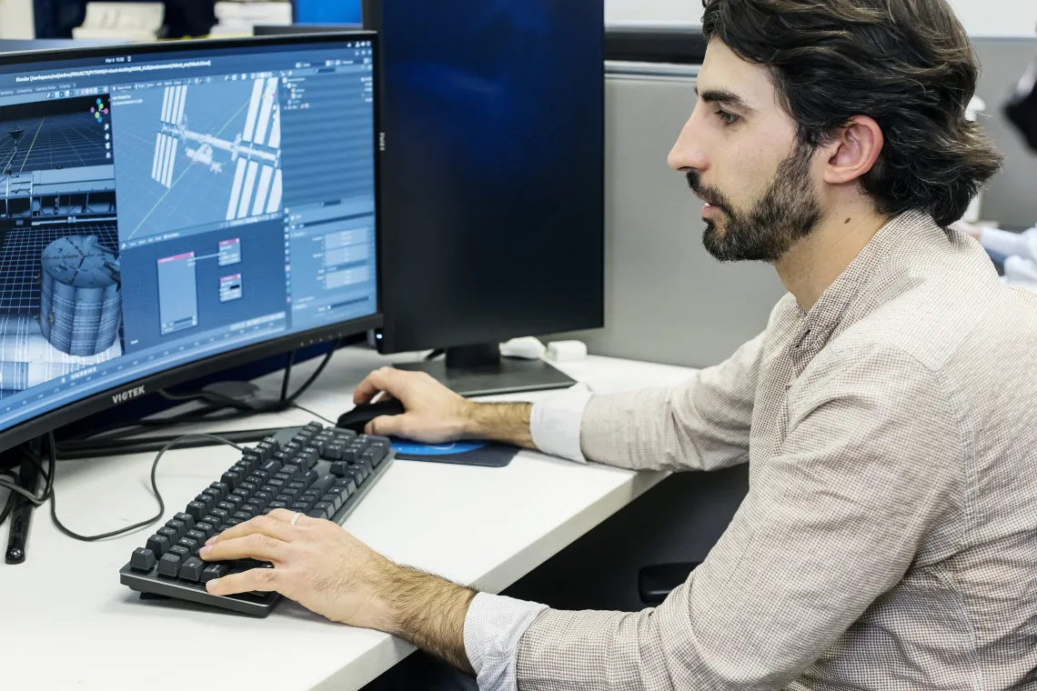 Photo of a student working at a computer.