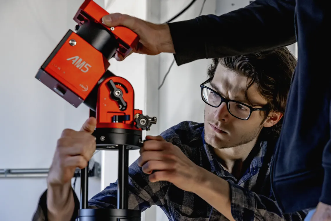 A photo of a student setting up equipment for Space4.