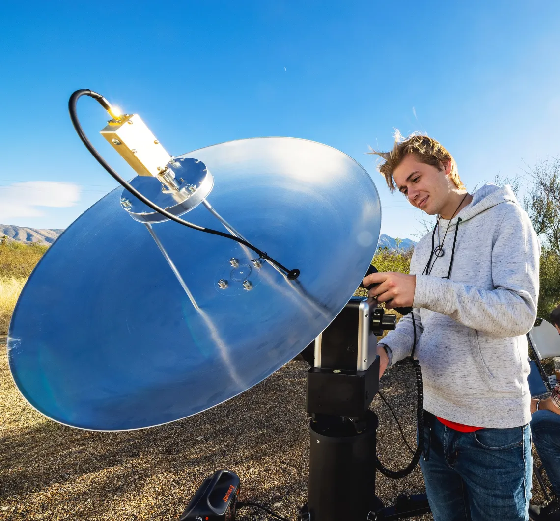 A photo of a student setting up an RF dish.