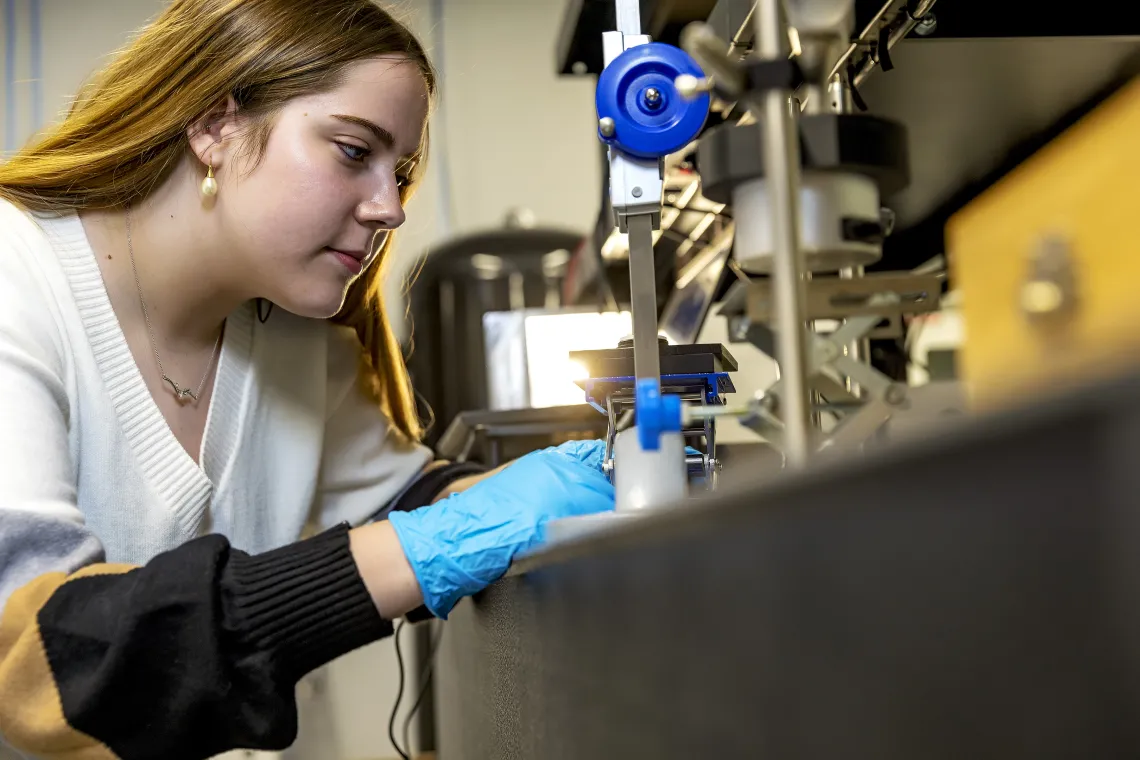 Photo of a student in a lab.